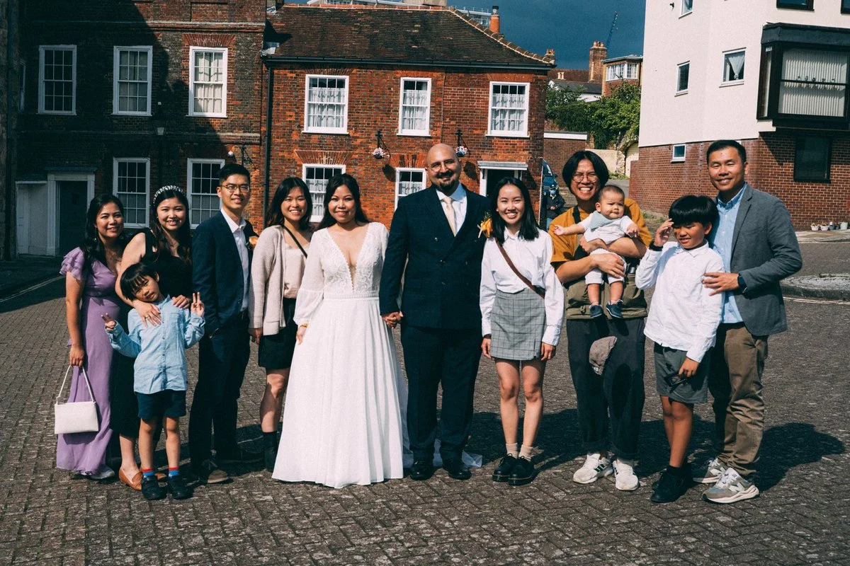 Newlyweds surrounded by family after their wedding ceremony