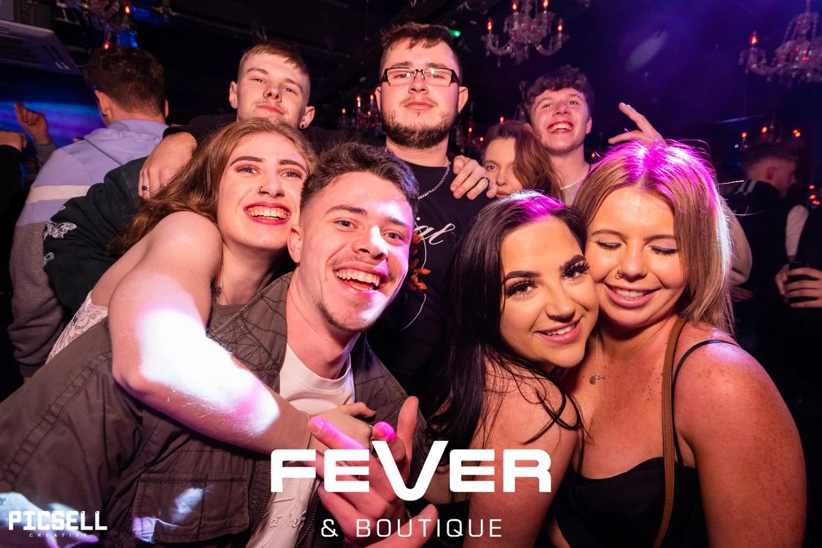 Energetic nightlife event with colourful lighting and dancing guests