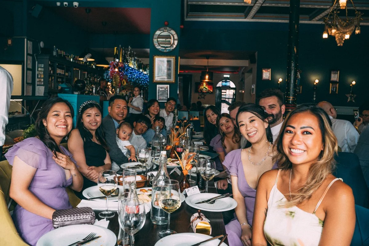 Elegant wedding reception dinner table with warm lighting and floral centrepieces